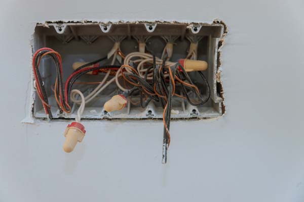New electrical installation, socket holes and electrical cables on the wall, renovation concept.