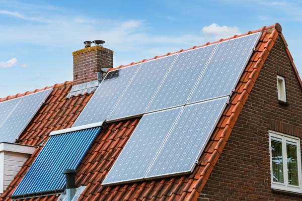 House with solar panels on the roof. Modern ecological energy resource. Green energy by sun.